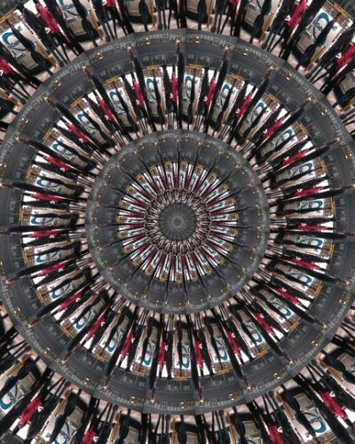 Algorithmically generated kaleidoscopic image consisting of a series of infinite-mirror-esque concentric discs, each one subdivided into multiple tranches that show the same image, albeit rotated by a consistent amount across the disc. In this case, the image that gets repeated across all discs at different angles is a photograph of a woman in a red jacket walking down the sidewalk flanked by two taller people in black jackets.