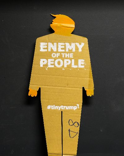 Same as previous image except the slogan is Enemy of the People.