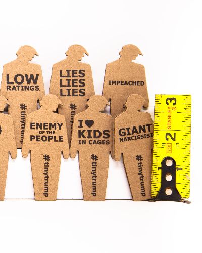 product shot of 24 tiny trumps with a ruler showing they are three inches tall