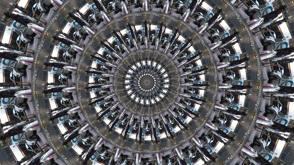 Algorithmically generated kaleidoscopic image consisting of a series of infinite-mirror-esque concentric discs, each one subdivided into multiple tranches that show the same image, albeit rotated by a consistent amount across the disc. In this case, the image that gets repeated across all discs at different angles is a photograph of a tall figure in a black coat holding white shopping bags. In the background is a white mini truck with a painted blue logo on its surface.
