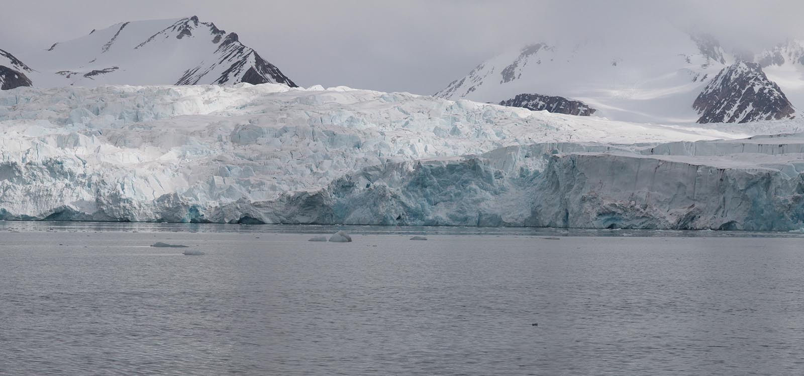 Panoramic photograph three of five: not much has changed, honestly. The camera continues its pan to the right revealing more of the same glacier and snow covered mountains.