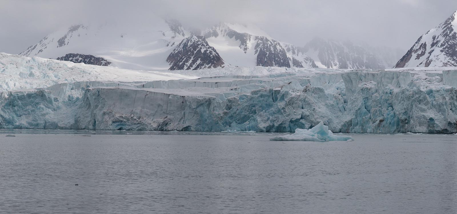 Panoramic photograph four of five: same old same old. Camera continues to pan to the right revealing more of the same  glacier and snow capped mountains