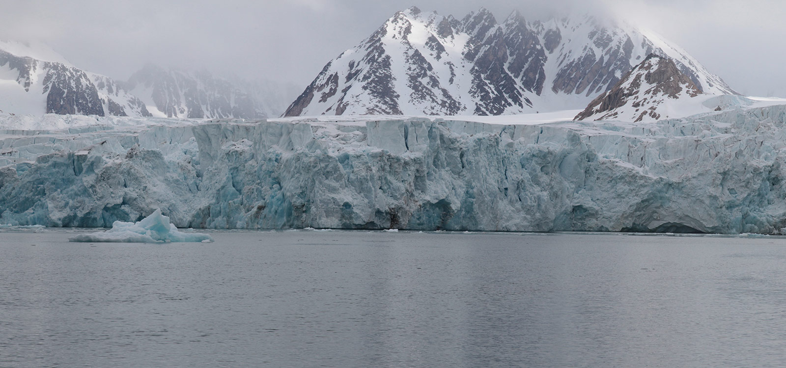 Panoramic photograph five of five: it feels like this image could go on forever. Same glacier and snow capped mountains, just more of them.