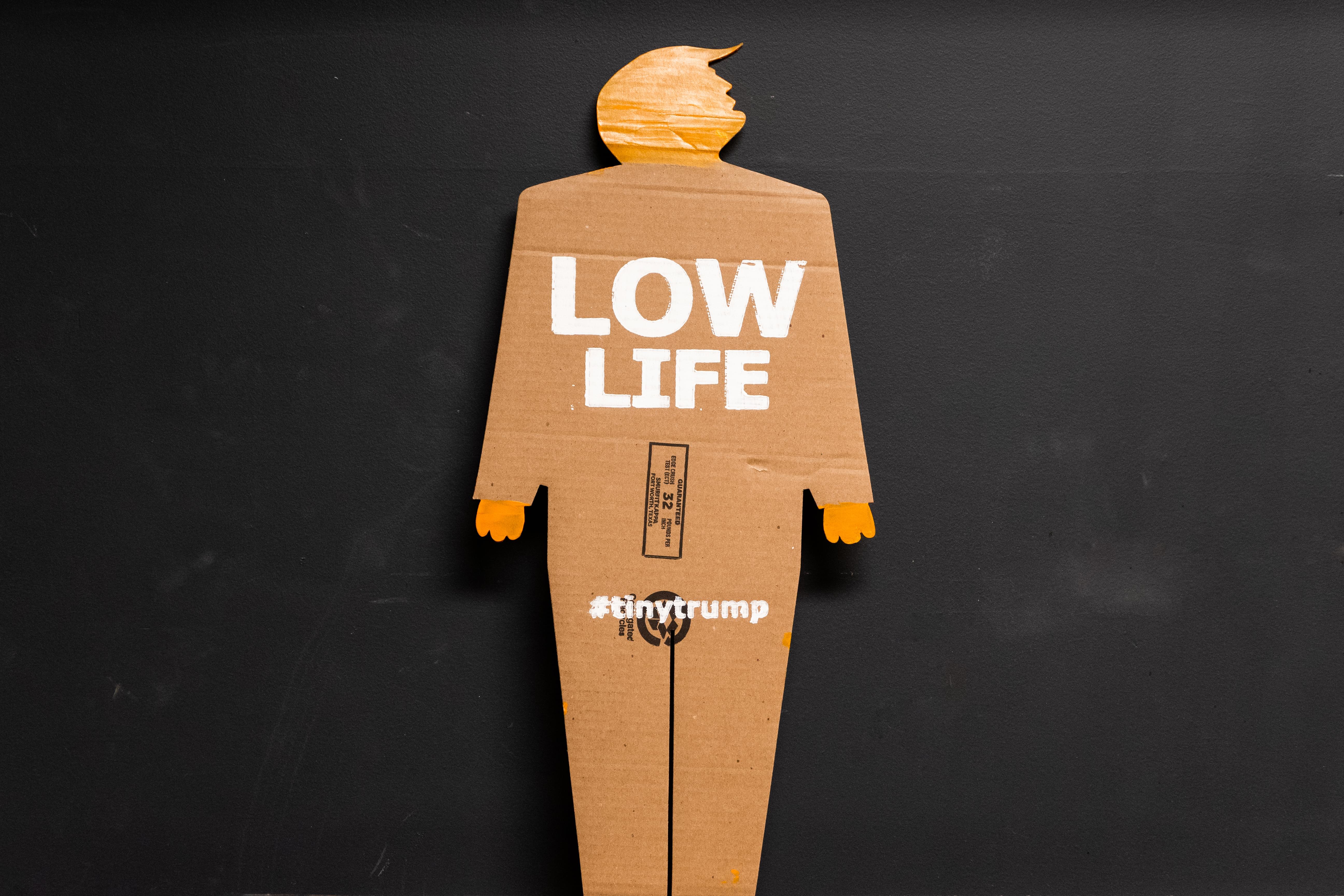 Same as previous image except the slogan is Low Life.