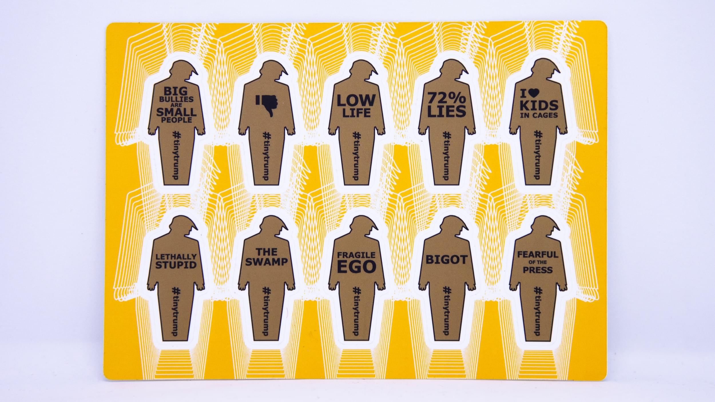 Product photograph of a 4 inch by 6 inch sticker sheet consisting of a yellow background and 12 individual tiny trumps with the following slogans: Big Bullies Are Small People, Thumbs Down, Low Life, 72% Lies, I love kids in cages, Lethally Stupid, The Swamp, Fragile Ego, Bigot, Fearful of the Press