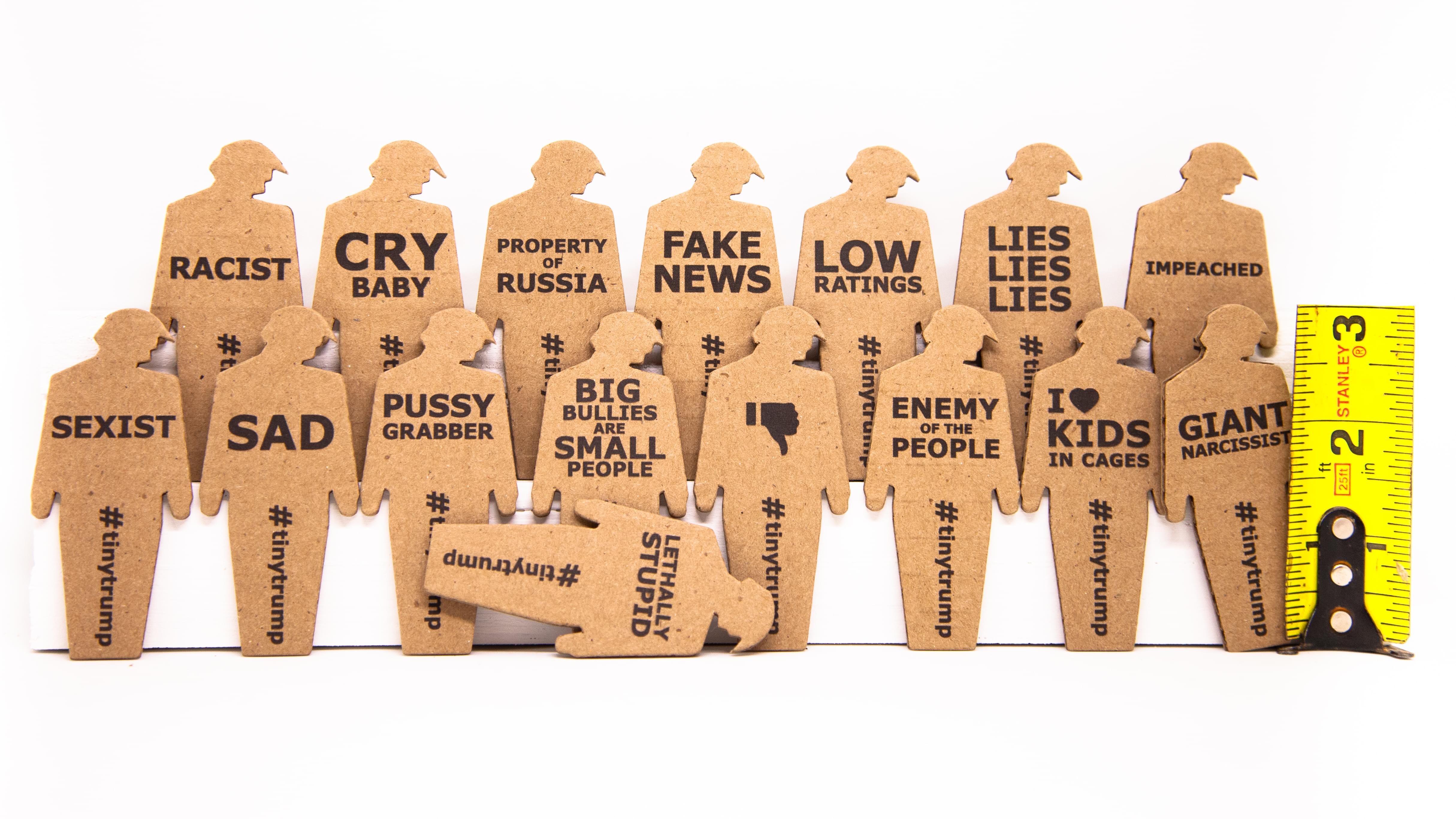 product shot of 24 tiny trumps with a ruler showing they are three inches tall
